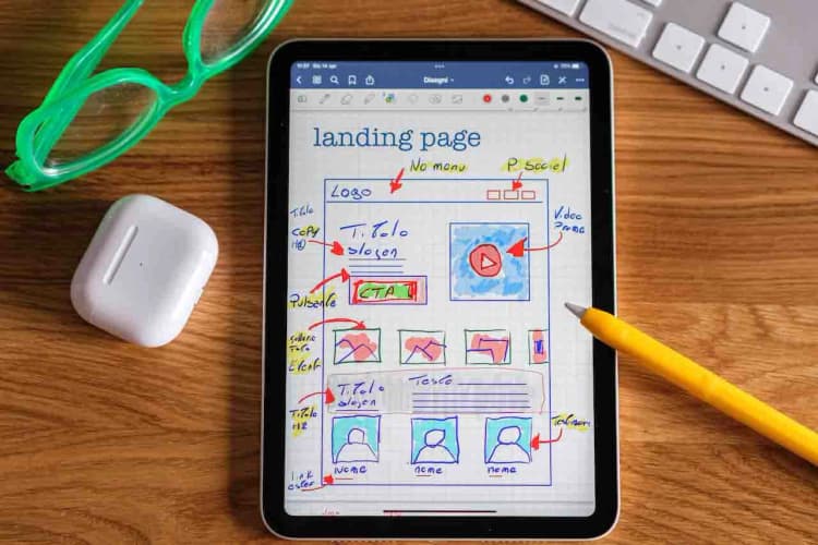 showing an image of a designing tablet where it shows the wireframe of an application website